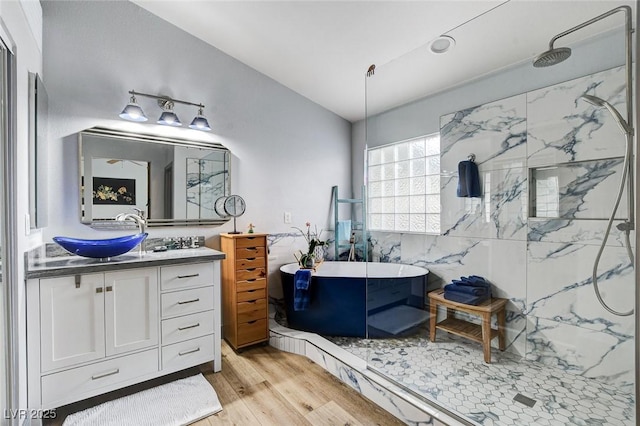 8926 Termoli St, Las Vegas, NV 89123 - full bath with vanity, wood finished floors, a marble finish shower, a soaking tub, and vaulted ceiling