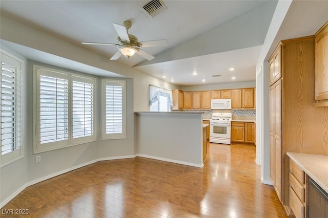 10009 Netherton Dr, Las Vegas, NV 89134 - kitchen with white appliances, a ceiling fan, light countertops, light wood-type flooring, and a peninsula