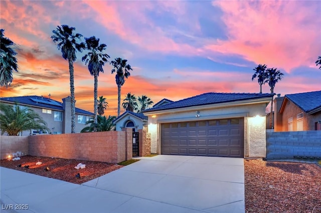 5509 Rose Thicket St, Las Vegas, NV 89130 - view of front of house featuring driveway, an attached garage, stucco siding, and a gate