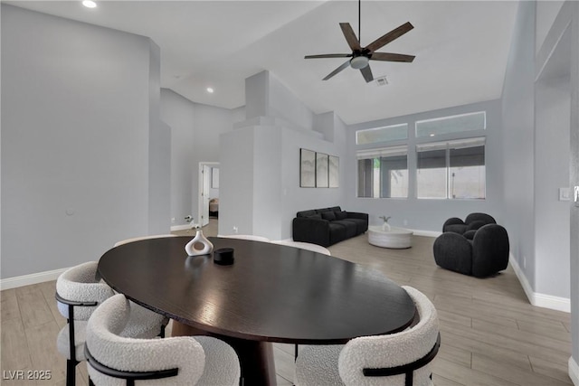 5509 Rose Thicket St, Las Vegas, NV 89130 - dining area with high vaulted ceiling, a ceiling fan, light wood finished floors, and recessed lighting