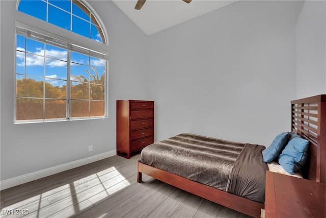 5509 Rose Thicket St, Las Vegas, NV 89130 - bedroom with multiple windows, vaulted ceiling, wood finished floors, and ceiling fan