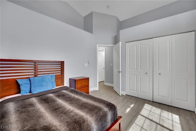 5509 Rose Thicket St, Las Vegas, NV 89130 - bedroom with high vaulted ceiling, a closet, and light wood-type flooring
