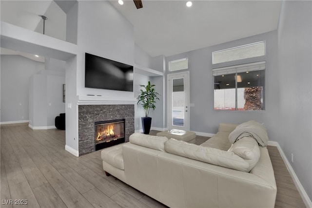 5509 Rose Thicket St, Las Vegas, NV 89130 - living room with high vaulted ceiling, wood finished floors, a fireplace, and recessed lighting