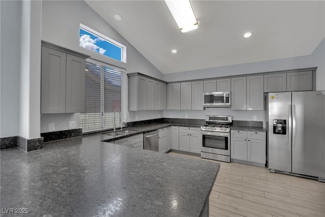 5509 Rose Thicket St, Las Vegas, NV 89130 - kitchen with appliances with stainless steel finishes, gray cabinetry, high vaulted ceiling, recessed lighting, and light wood-style floors