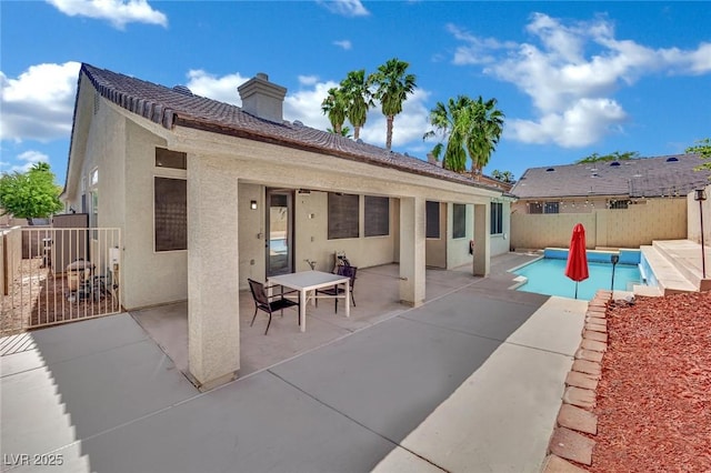 5509 Rose Thicket St, Las Vegas, NV 89130 - back of property with stucco siding, a patio, a chimney, and a fenced backyard
