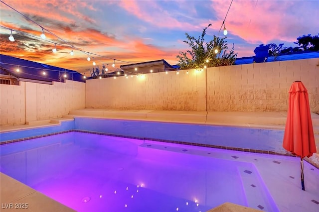 5509 Rose Thicket St, Las Vegas, NV 89130 - pool at dusk with a fenced backyard
