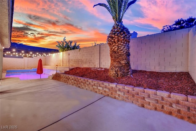 5509 Rose Thicket St, Las Vegas, NV 89130 - patio terrace at dusk with a fenced backyard and a patio area