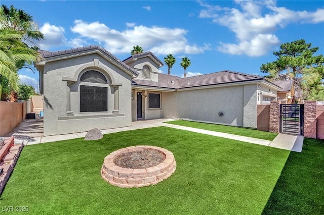 5509 Rose Thicket St, Las Vegas, NV 89130 - back of property featuring a gate, a fenced backyard, stucco siding, and a tile roof