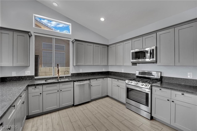 5509 Rose Thicket St, Las Vegas, NV 89130 - kitchen with appliances with stainless steel finishes, gray cabinetry, recessed lighting, light wood finished floors, and high vaulted ceiling