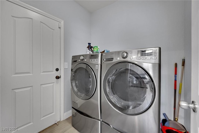 5509 Rose Thicket St, Las Vegas, NV 89130 - laundry area with washing machine and clothes dryer and light wood finished floors