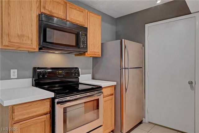 201 Mission Laguna Ln Unit 104, Las Vegas, NV 89107 - kitchen featuring appliances with stainless steel finishes, light countertops, light tile patterned floors, and light brown cabinets