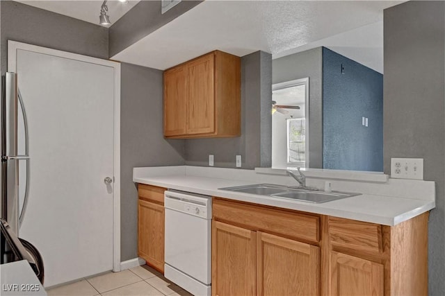 201 Mission Laguna Ln Unit 104, Las Vegas, NV 89107 - kitchen featuring white dishwasher, light tile patterned floors, light countertops, and a ceiling fan