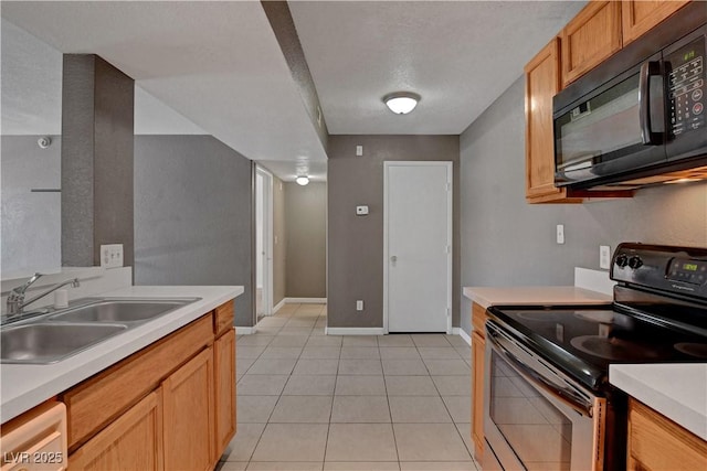201 Mission Laguna Ln Unit 104, Las Vegas, NV 89107 - kitchen with electric stove, black microwave, light countertops, light tile patterned floors, and white dishwasher