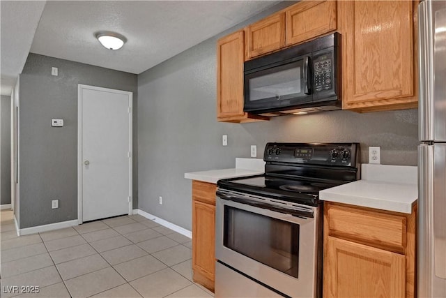 201 Mission Laguna Ln Unit 104, Las Vegas, NV 89107 - kitchen featuring stainless steel appliances, light countertops, and light tile patterned flooring