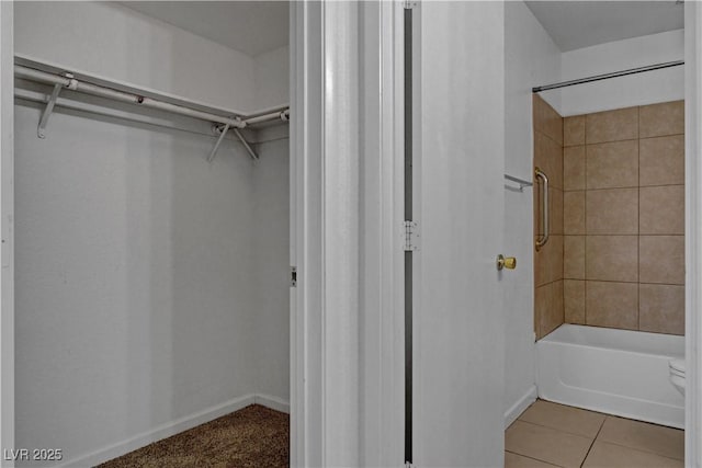 201 Mission Laguna Ln Unit 104, Las Vegas, NV 89107 - full bath with a walk in closet, shower / washtub combination, and tile patterned flooring