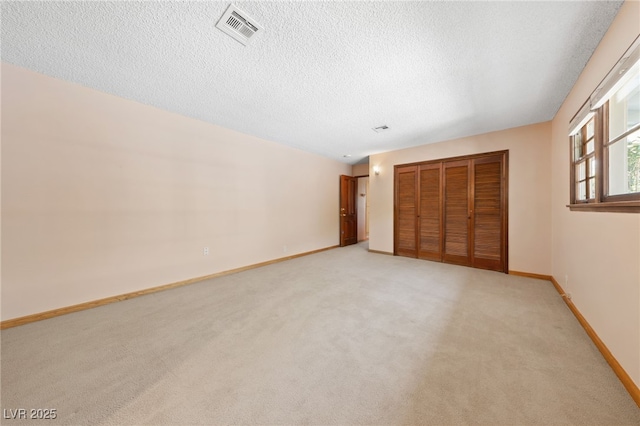 2400 Llewellyn Dr, Las Vegas, NV 89102 - unfurnished bedroom featuring light colored carpet, a textured ceiling, and a closet