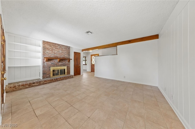 2400 Llewellyn Dr, Las Vegas, NV 89102 - unfurnished living room with a textured ceiling, light tile patterned floors, and a brick fireplace