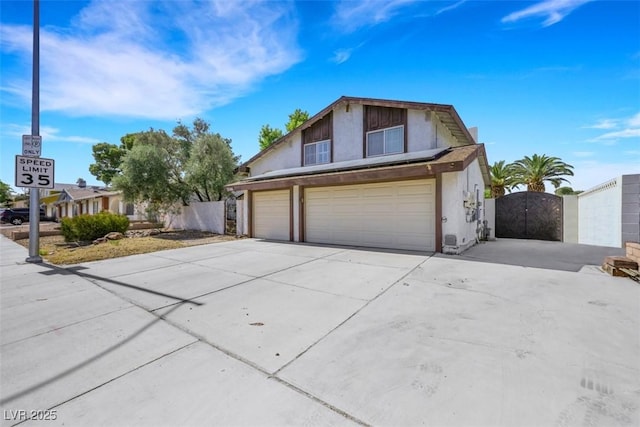 3746 E Harmon Ave, Las Vegas, NV 89121 - view of front of property featuring a gate, concrete driveway, an attached garage, and stucco siding