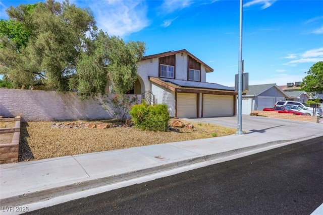 3746 E Harmon Ave, Las Vegas, NV 89121 - view of front of home with an attached garage, driveway, and stucco siding