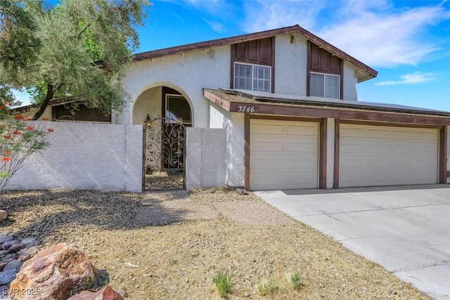 3746 E Harmon Ave, Las Vegas, NV 89121 - view of front of home featuring a garage, concrete driveway, and stucco siding