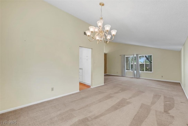 3746 E Harmon Ave, Las Vegas, NV 89121 - unfurnished room with vaulted ceiling, light carpet, and a chandelier
