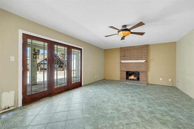 3746 E Harmon Ave, Las Vegas, NV 89121 - unfurnished living room with french doors, a ceiling fan, a fireplace, and tile patterned flooring