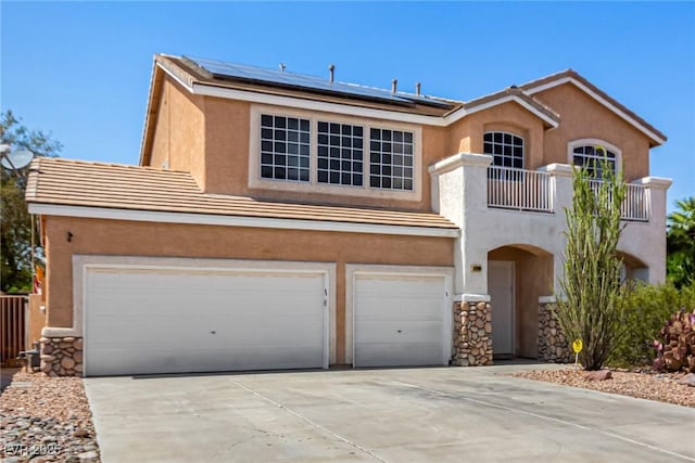 1798 Lakewood Dr, Henderson, NV 89012 - view of front of home featuring a balcony, a garage, stucco siding, solar panels, and concrete driveway