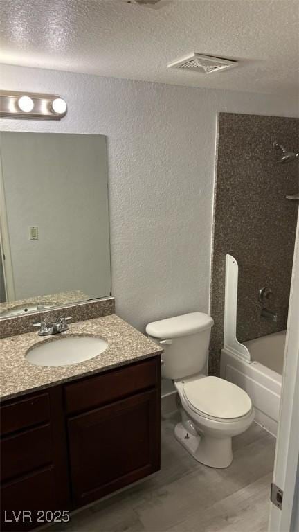 2606 S Durango Dr Unit 142, Las Vegas, NV 89117 - bathroom featuring a textured wall, vanity, a textured ceiling, and washtub / shower combination