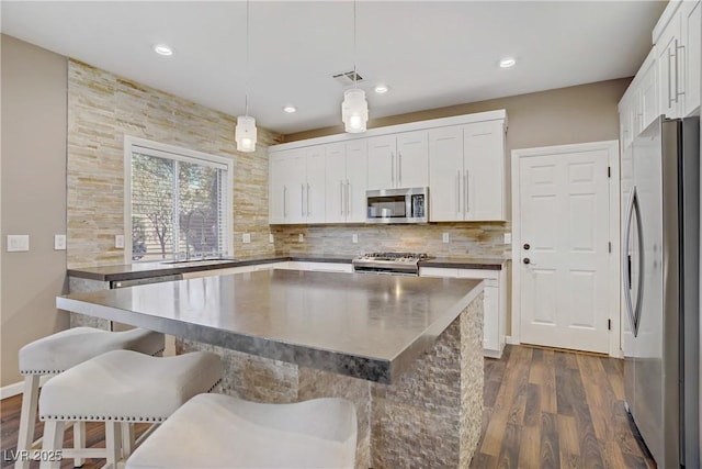 3420 Lockport St, Las Vegas, NV 89129 - kitchen with stainless steel appliances, dark wood-style floors, white cabinetry, decorative backsplash, and recessed lighting