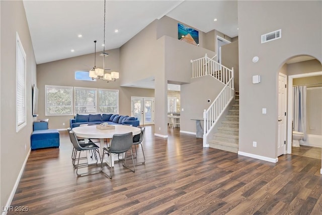3420 Lockport St, Las Vegas, NV 89129 - dining space featuring high vaulted ceiling, wood finished floors, stairs, a chandelier, and arched walkways