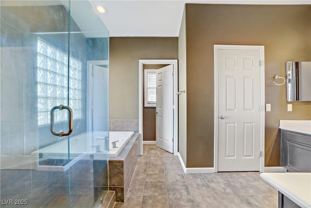 3420 Lockport St, Las Vegas, NV 89129 - bathroom with vanity, a garden tub, a shower stall, and tile patterned floors