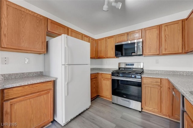 4751 Lone Grove Dr, Las Vegas, NV 89139 - kitchen with stainless steel appliances, light wood-style flooring, and light countertops