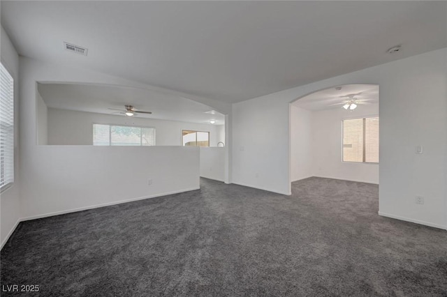 4751 Lone Grove Dr, Las Vegas, NV 89139 - spare room featuring ceiling fan, arched walkways, dark carpet, and a smoke detector