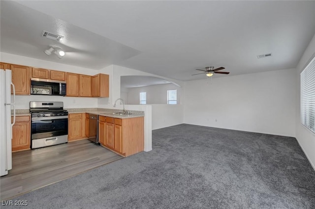 4751 Lone Grove Dr, Las Vegas, NV 89139 - kitchen featuring appliances with stainless steel finishes, ceiling fan, a peninsula, light countertops, and arched walkways