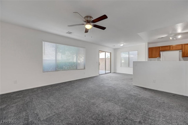 4751 Lone Grove Dr, Las Vegas, NV 89139 - unfurnished living room with ceiling fan and dark carpet