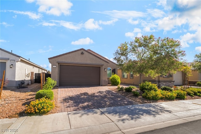 3782 Neblina Dr, Henderson, NV 89052 - view of front facade with stucco siding, decorative driveway, and a garage