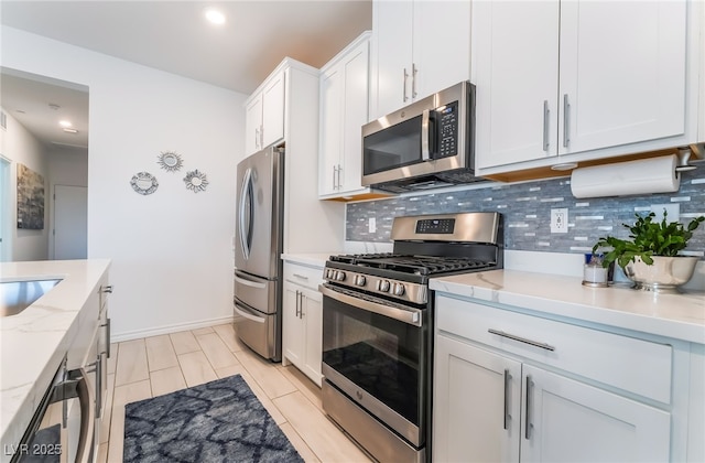 3782 Neblina Dr, Henderson, NV 89052 - kitchen with appliances with stainless steel finishes, backsplash, white cabinetry, light stone counters, and recessed lighting