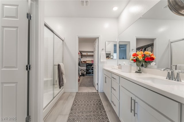 3782 Neblina Dr, Henderson, NV 89052 - bathroom featuring a spacious closet, double vanity, a stall shower, and tile patterned flooring