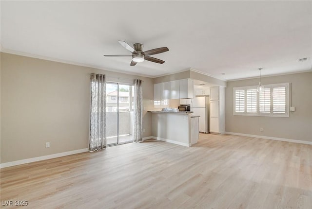 7300 Pirates Cove Rd Unit 1032, Las Vegas, NV 89145 - unfurnished living room featuring ornamental molding, ceiling fan, and light wood finished floors