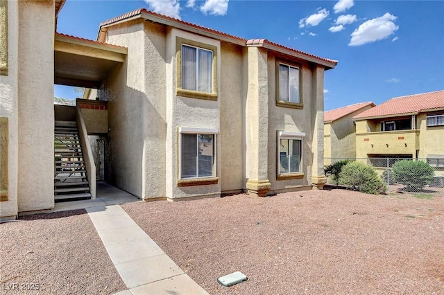 7300 Pirates Cove Rd Unit 1032, Las Vegas, NV 89145 - view of front facade with stairs, stucco siding, and a tiled roof