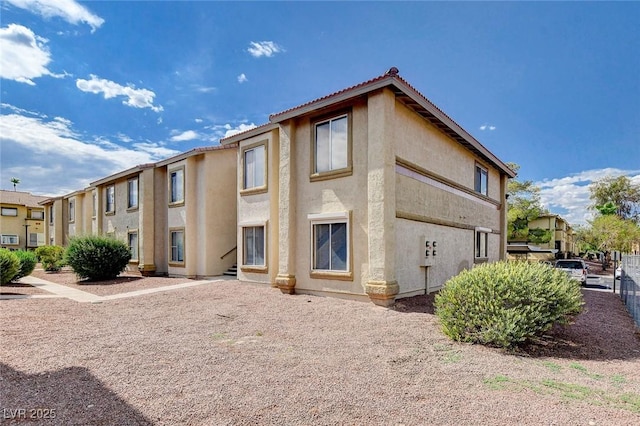 7300 Pirates Cove Rd Unit 1032, Las Vegas, NV 89145 - view of front of house with stucco siding and a tile roof