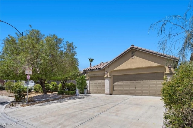 9233 Onyx Point Ct, Henderson, NV 89074 - view of front of house with stucco siding, driveway, an attached garage, and a tile roof