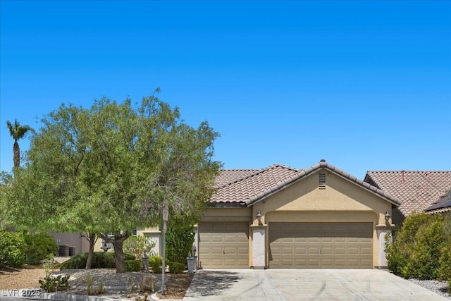 9233 Onyx Point Ct, Henderson, NV 89074 - view of front of house with an attached garage, stucco siding, driveway, and a tiled roof