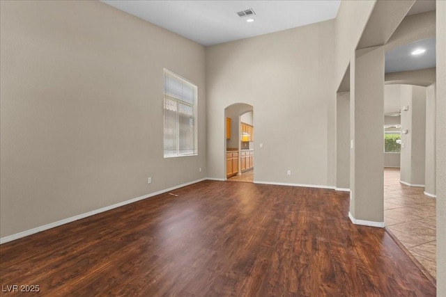 9233 Onyx Point Ct, Henderson, NV 89074 - empty room featuring arched walkways and wood finished floors
