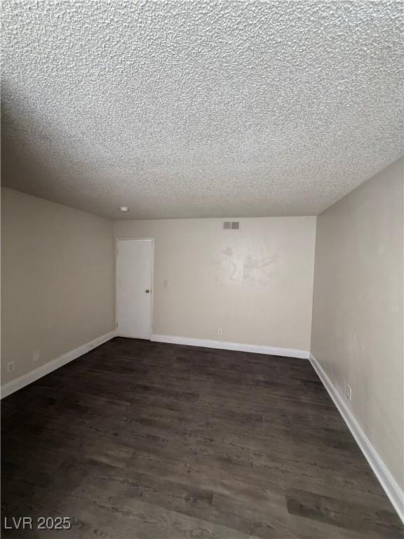 4941 Newport Cove Dr Unit B, Las Vegas, NV 89119 - unfurnished room with a textured ceiling and dark wood finished floors