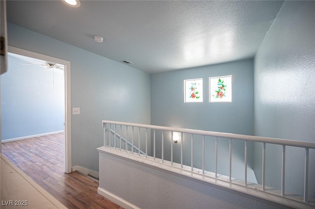 6524 Rain Forest Dr, Las Vegas, NV 89108 - hallway featuring wood finished floors, an upstairs landing, and recessed lighting