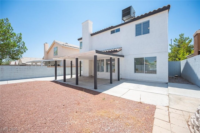 6524 Rain Forest Dr, Las Vegas, NV 89108 - rear view of house featuring a fenced backyard, stucco siding, a patio, and a tiled roof