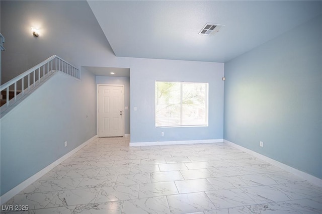 6524 Rain Forest Dr, Las Vegas, NV 89108 - spare room featuring marble look tiles and stairway