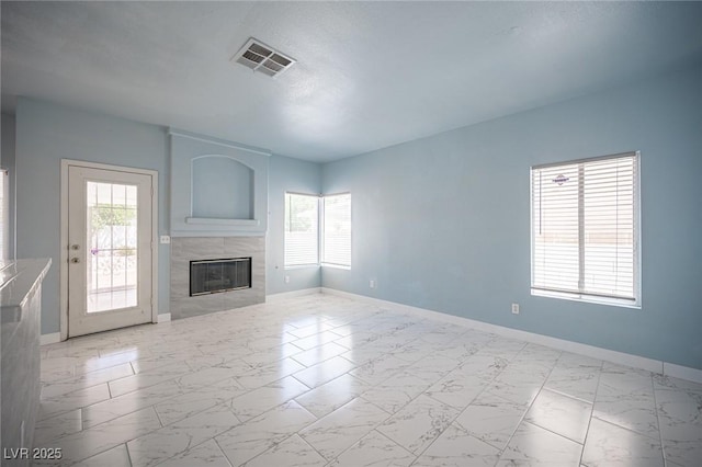 6524 Rain Forest Dr, Las Vegas, NV 89108 - unfurnished living room with marble look tile flooring, plenty of natural light, and a fireplace