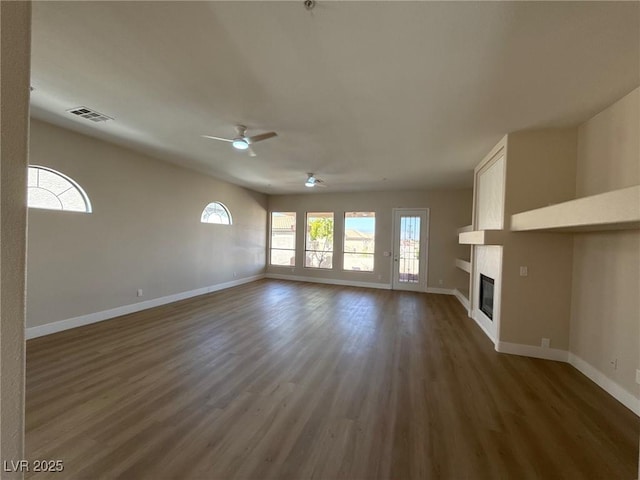 379 Marlin Cove Rd, Henderson, NV 89012 - unfurnished living room featuring a ceiling fan, a large fireplace, and wood finished floors